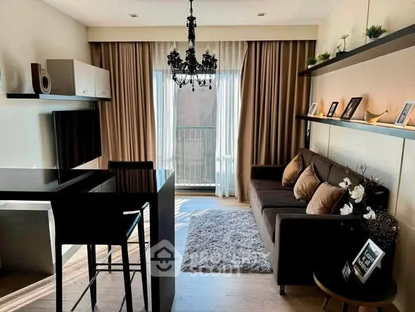 Stylish modern living room with elegant chandelier and cozy seating area.