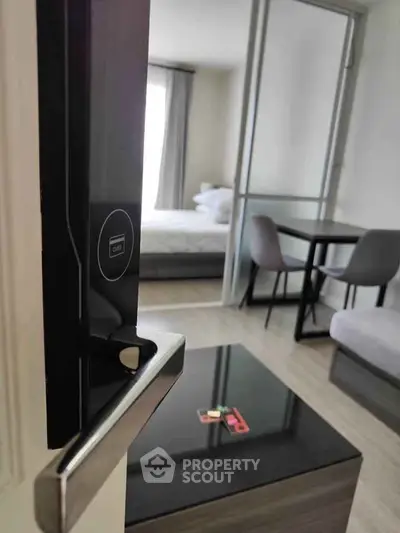 Modern apartment interior with sleek furniture and smart lock entry, showcasing a cozy living space.