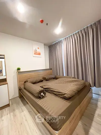 Modern bedroom with stylish decor and cozy ambiance in a real estate property.