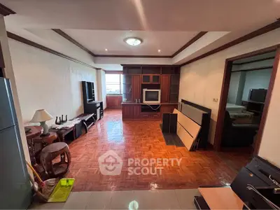 Spacious living room with wooden flooring and built-in entertainment center