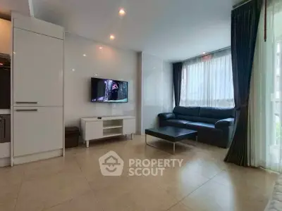 Spacious modern living room with sleek furniture and large windows.