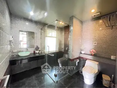 Luxurious modern bathroom with glass shower and elegant fixtures