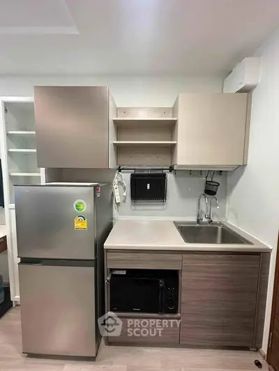 Modern compact kitchen with sleek cabinetry and stainless steel appliances