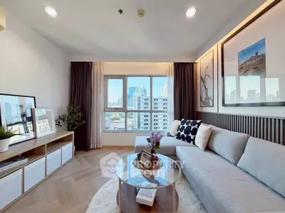 Modern living room with city view, stylish decor, and natural light