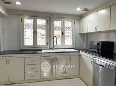 Spacious kitchen with modern appliances and ample storage in a bright, airy setting.