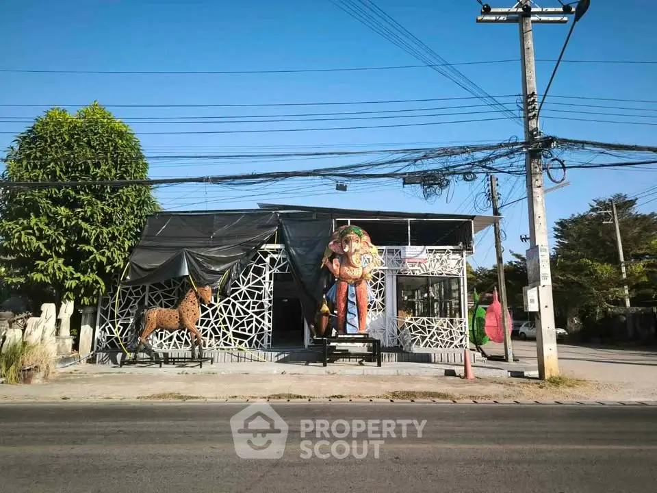 Unique commercial property with artistic facade and sculptures, ideal for creative businesses.