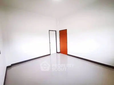 Spacious empty room with white walls and tiled floor, ideal for customization.