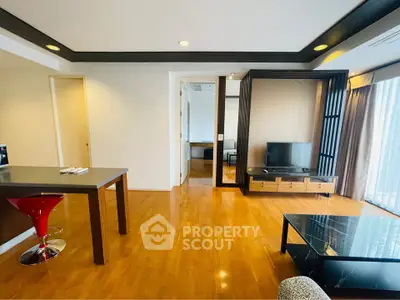 Spacious modern living room with wooden flooring and stylish furniture