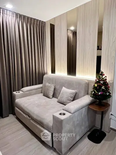 Cozy living room with modern sofa and elegant curtains, perfect for relaxation.