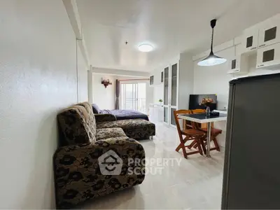 Spacious studio apartment with modern furnishings and balcony view