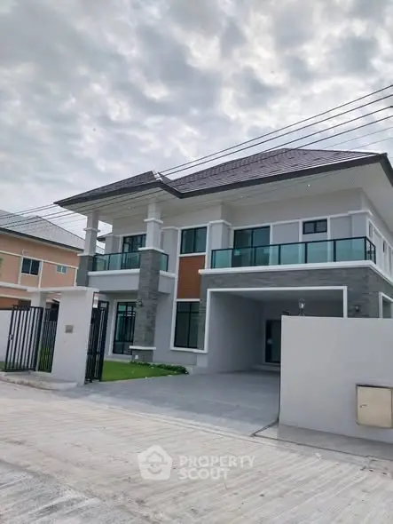 Stunning modern two-story house with spacious driveway and elegant facade in a serene neighborhood.