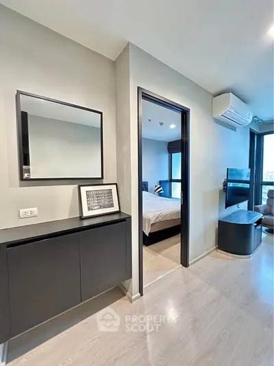 Modern apartment interior with sleek design, featuring a stylish bedroom and living area with air conditioning.