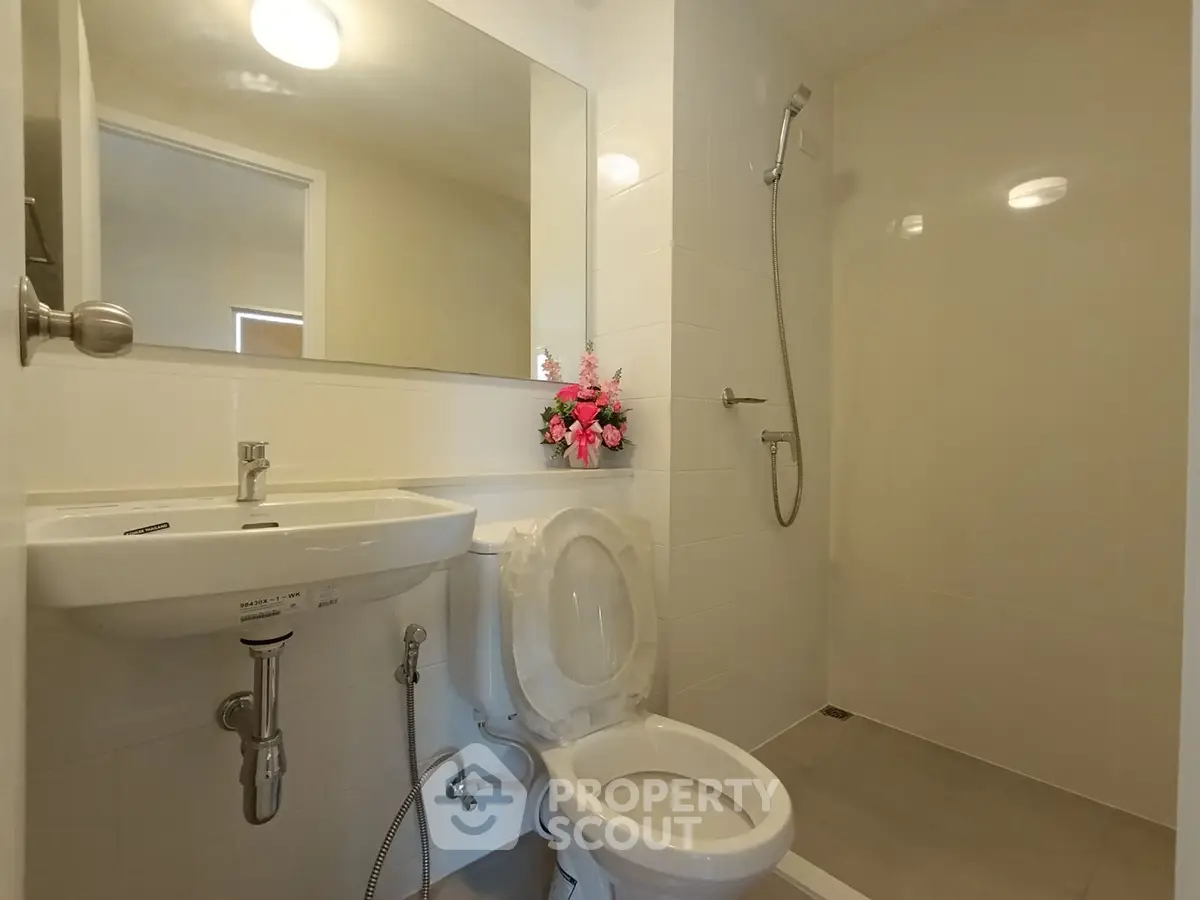 Modern bathroom with sleek fixtures and a walk-in shower, perfect for a contemporary home.