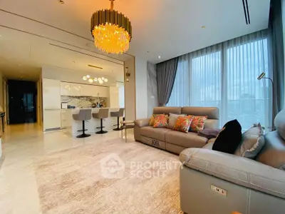 Luxurious living room with elegant chandelier and open kitchen layout in modern apartment