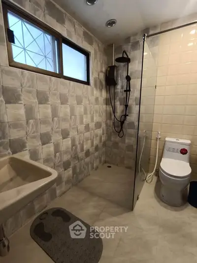 Modern bathroom with shower and toilet in neutral tones