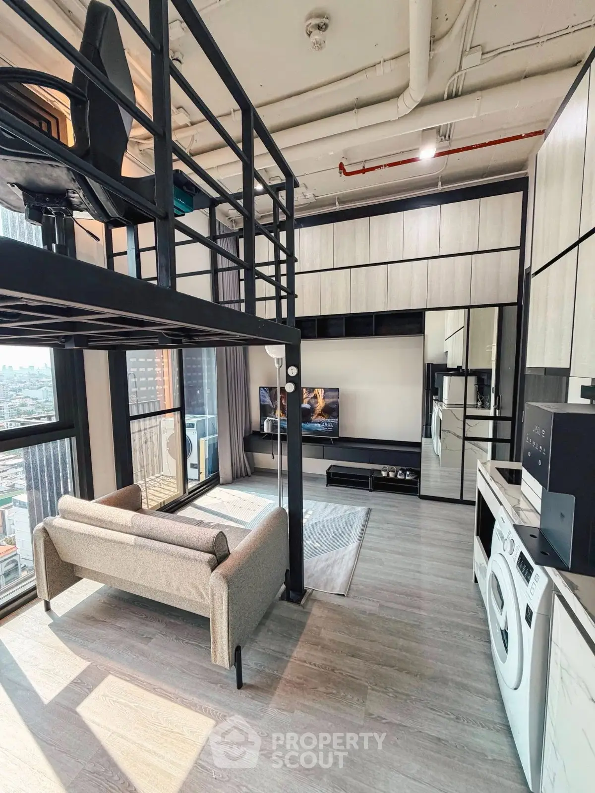 Modern loft apartment with mezzanine, stylish living area, and city view.