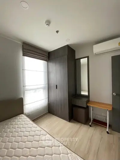 Modern bedroom with sleek wardrobe and natural light