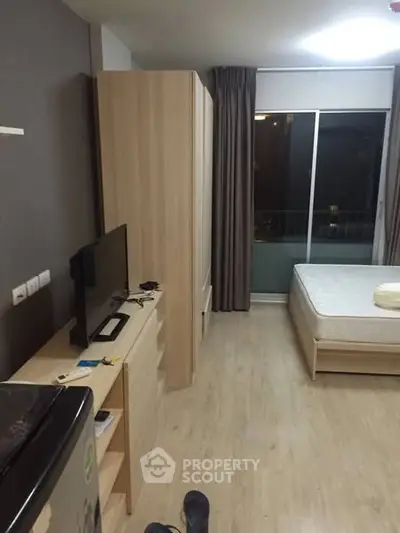 Modern studio apartment with wooden flooring and minimalist furniture
