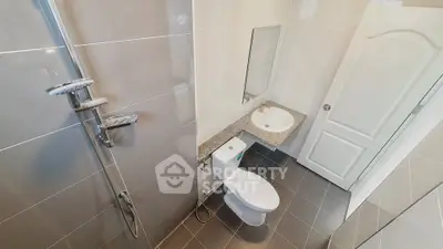 Modern bathroom with sleek fixtures and neutral tiles