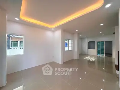 Spacious modern living room with elegant lighting and glossy tiled floors