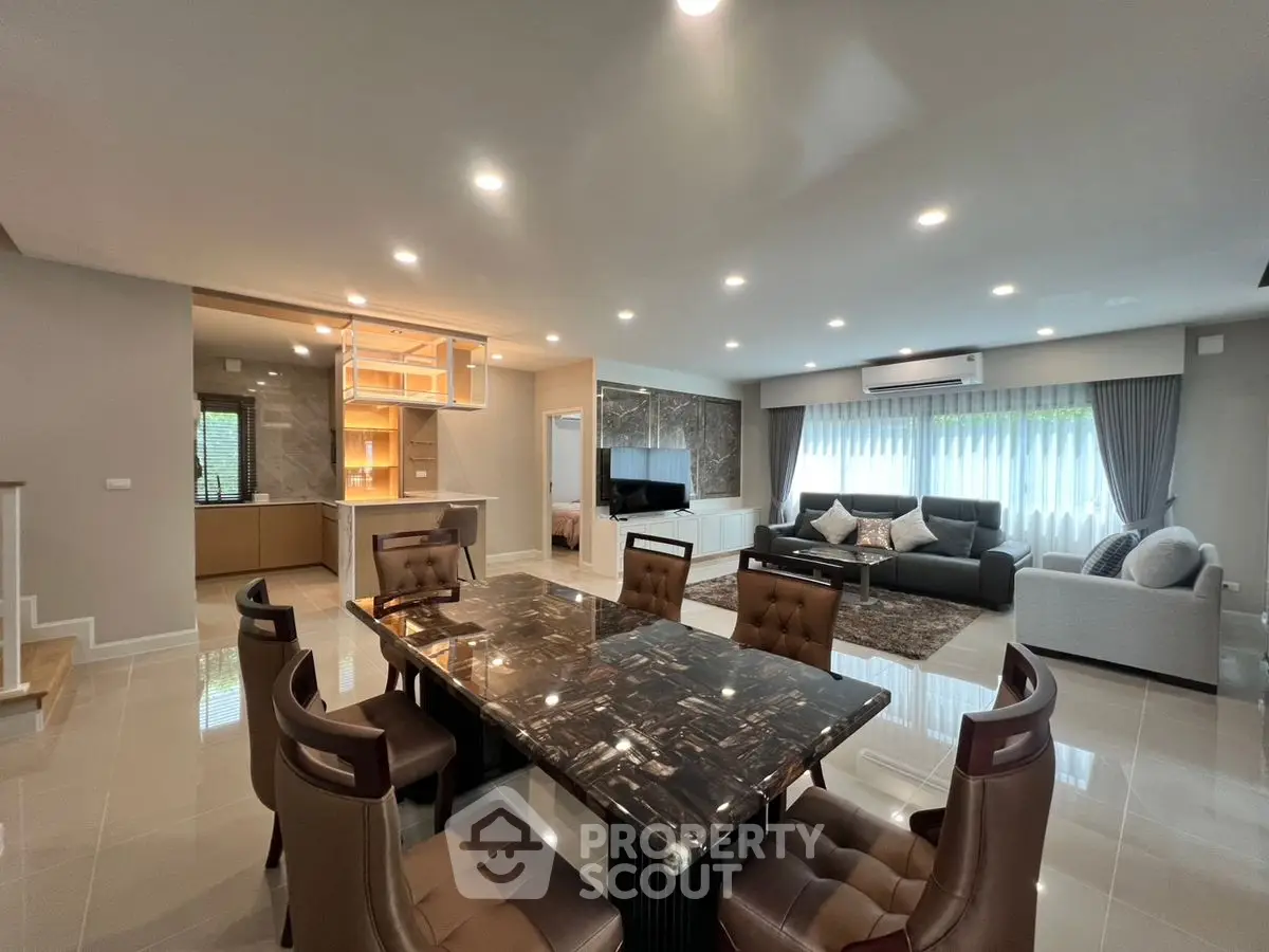 Spacious open-plan living and dining area with modern furnishings and ample natural light.