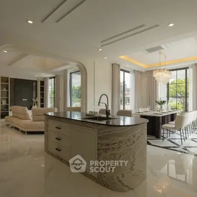Luxurious open-plan living room and kitchen with elegant decor and large windows.