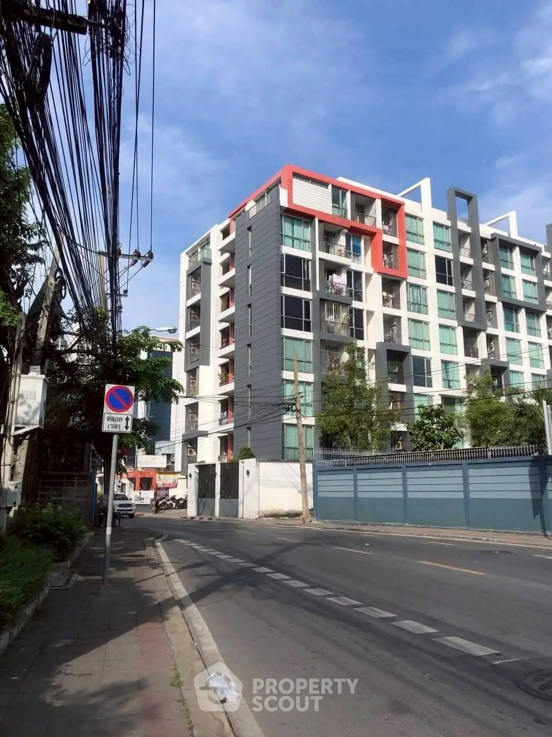 Modern urban apartment building with unique architectural design and vibrant accents.