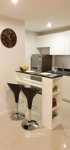 Modern kitchen with sleek bar stools and stainless steel appliances