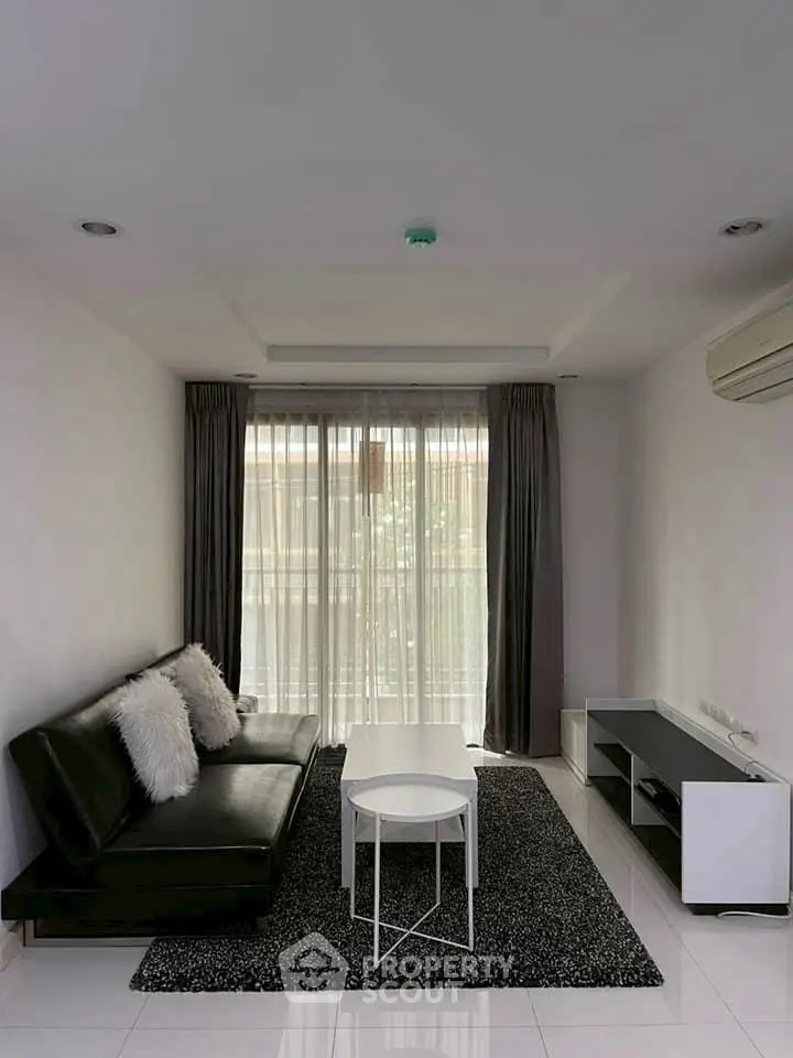 Modern living room with sleek black sofa and stylish decor