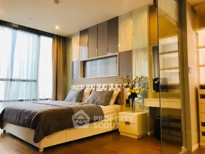 Luxurious bedroom with modern decor and large windows for natural light