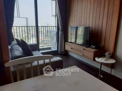 Modern living room with balcony view and stylish wooden accents.