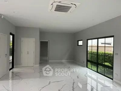 Spacious modern living room with marble flooring and large windows