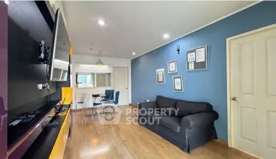 Modern living room with blue accent wall and cozy seating area