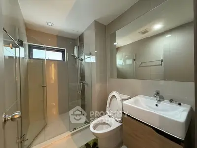 Modern bathroom with glass shower and sleek fixtures