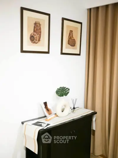 Stylish interior decor with framed art and elegant console table in modern living space.