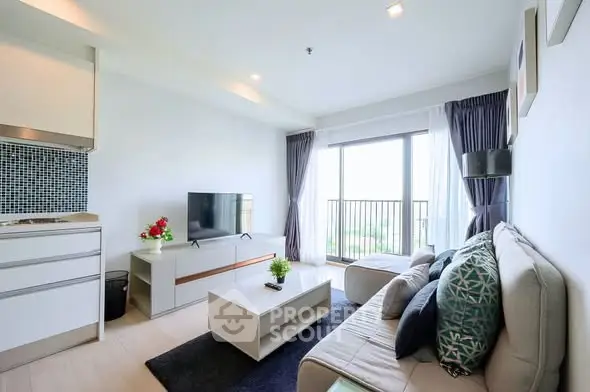 Modern living room with sleek furniture and large window offering natural light.