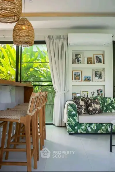 Stylish living room with tropical decor and bar seating, perfect for relaxation.