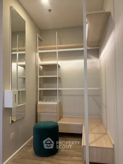 Spacious walk-in closet with modern shelving and seating in a stylish home.