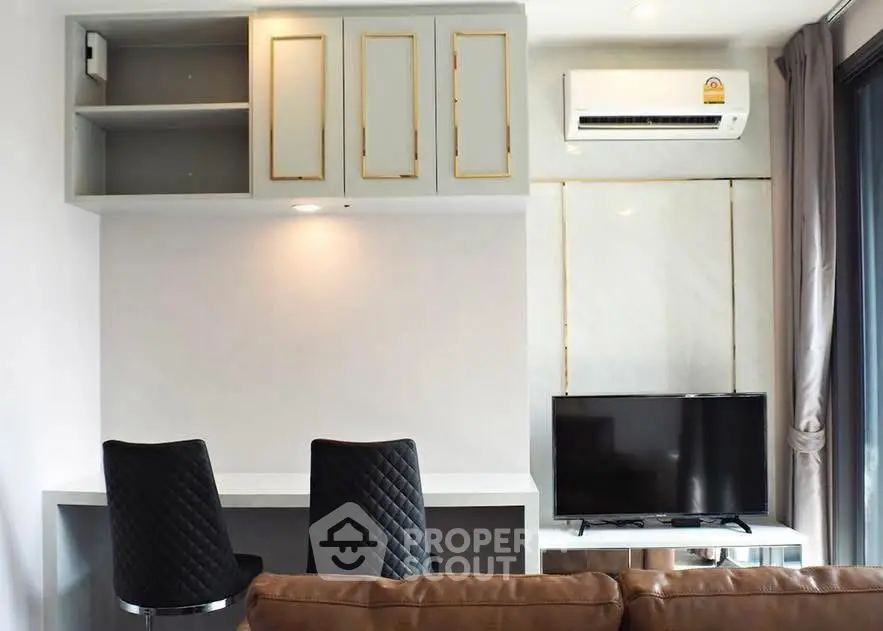 Modern living room with stylish furniture and wall-mounted TV