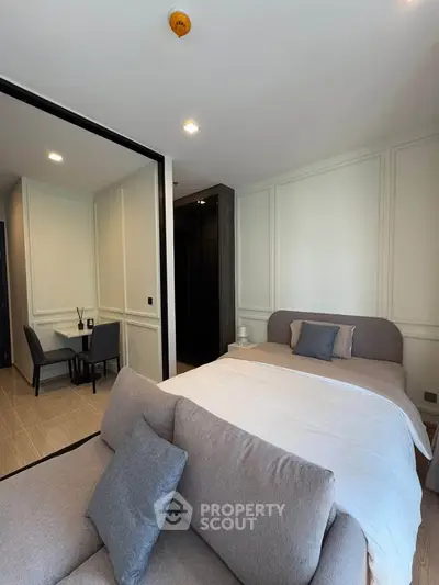 Modern bedroom with cozy bed and stylish decor in a contemporary apartment.