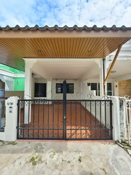 Charming townhouse with gated entrance and covered carport in a quiet neighborhood.