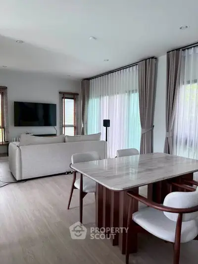 Modern living room with elegant dining area and large windows