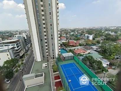 High-rise building with tennis court and cityscape view