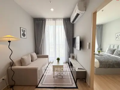 Modern living room with cozy sofa, stylish decor, and natural light in a contemporary apartment.