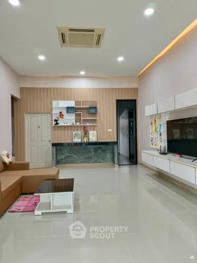Spacious modern living room with sleek design and ample natural light, perfect for family gatherings.
