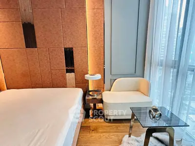 Luxurious bedroom with modern design, featuring elegant furniture and floor-to-ceiling windows for natural light.