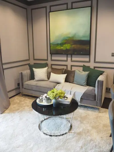 Elegant living room with modern sofa, stylish decor, and plush carpet