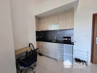 Modern compact kitchen with sleek cabinetry and workspace in a stylish apartment