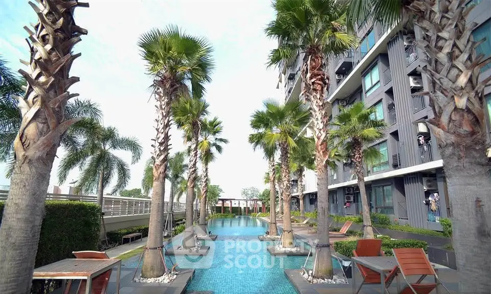 Luxurious apartment complex with stunning pool and palm trees, perfect for relaxation and leisure.