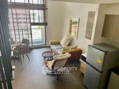 Modern living room with stylish furniture and large windows offering ample natural light.